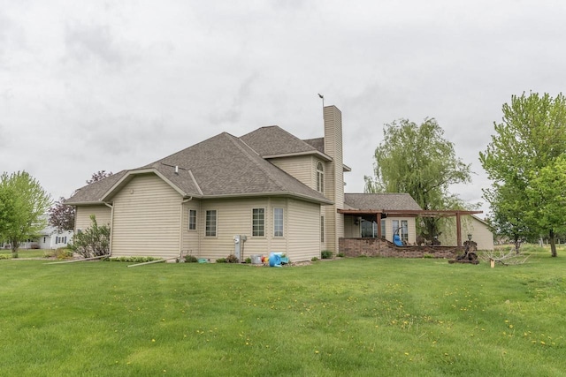 315 N 7th St, Colby, WI 54421 - rear view of property with a chimney, a lawn, and roof with shingles