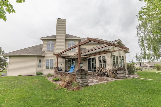 315 N 7th St, Colby, WI 54421 - back of house featuring a patio, a chimney, a lawn, and a shingled roof