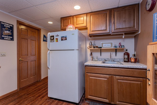 315 N 7th St, Colby, WI 54421 - kitchen with freestanding refrigerator, a sink, dark wood-style floors, a drop ceiling, and light countertops
