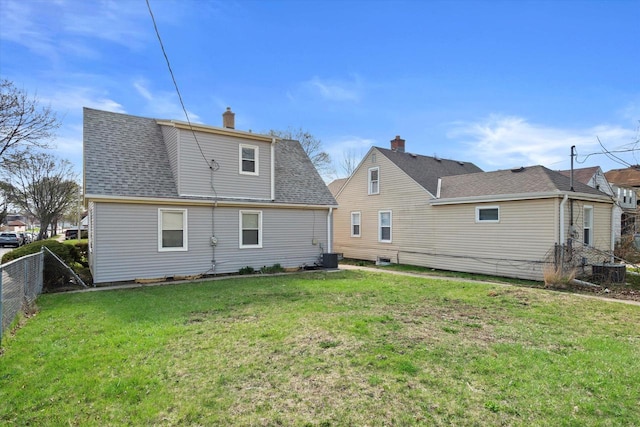 4193 N 19th Pl, Milwaukee, WI 53209 - back of property featuring a shingled roof, a chimney, and central AC unit