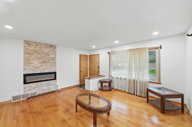 4349 N 80th St, Milwaukee, WI 53222 - living room featuring a stone fireplace, wood finished floors, recessed lighting, and baseboards