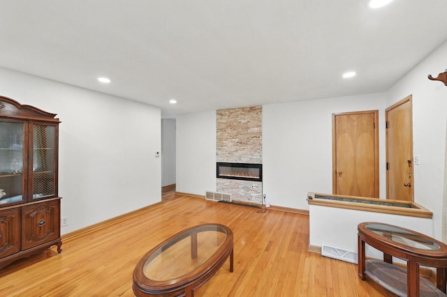 4349 N 80th St, Milwaukee, WI 53222 - living area with light wood-style floors, recessed lighting, a stone fireplace, and baseboards