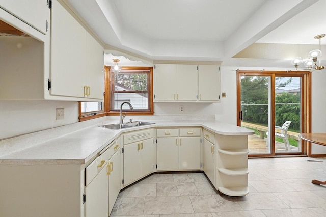 4349 N 80th St, Milwaukee, WI 53222 - kitchen featuring a sink, light countertops, open shelves, and a peninsula