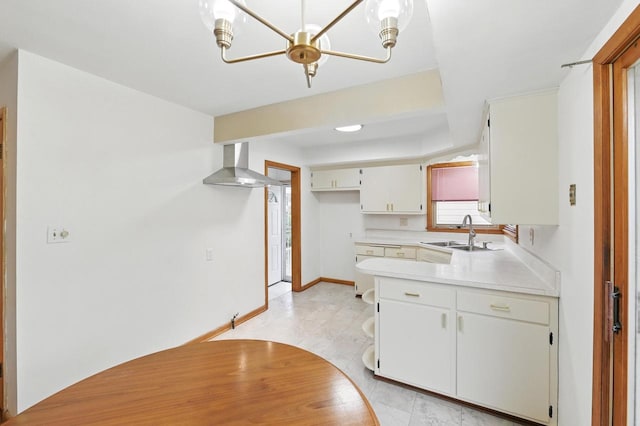 4349 N 80th St, Milwaukee, WI 53222 - kitchen featuring a sink, wall chimney range hood, light countertops, a peninsula, and baseboards