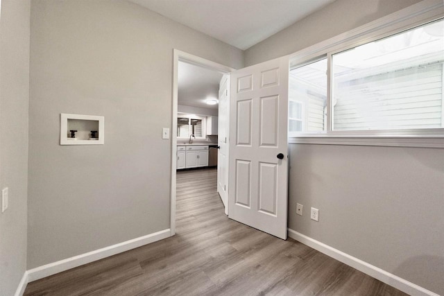 2107 W Grand Ave, Beloit, WI 53511 - washroom with washer hookup, wood finished floors, plenty of natural light, and baseboards