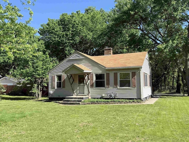 2107 W Grand Ave, Beloit, WI 53511 - view of front of property with a chimney, a front lawn, and a shingled roof