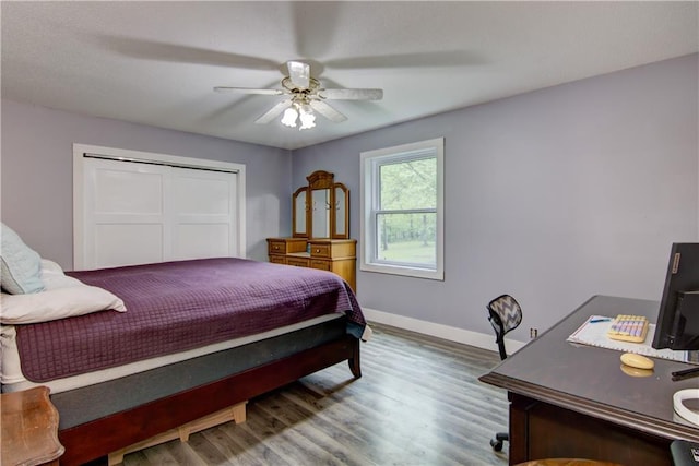 8054 223rd St, Cadott, WI 54727 - bedroom featuring baseboards, wood finished floors, a closet, and a ceiling fan