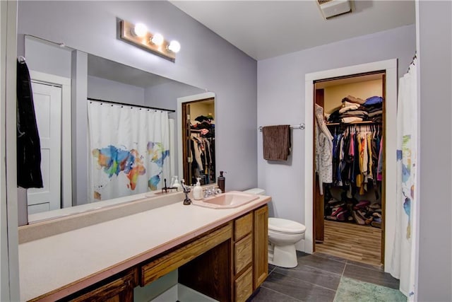 8054 223rd St, Cadott, WI 54727 - bathroom with vanity, toilet, a spacious closet, and a shower with curtain