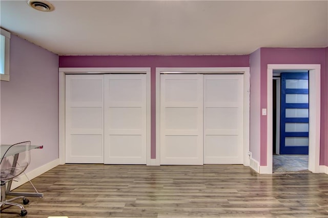 8054 223rd St, Cadott, WI 54727 - unfurnished bedroom featuring two closets, baseboards, and wood finished floors