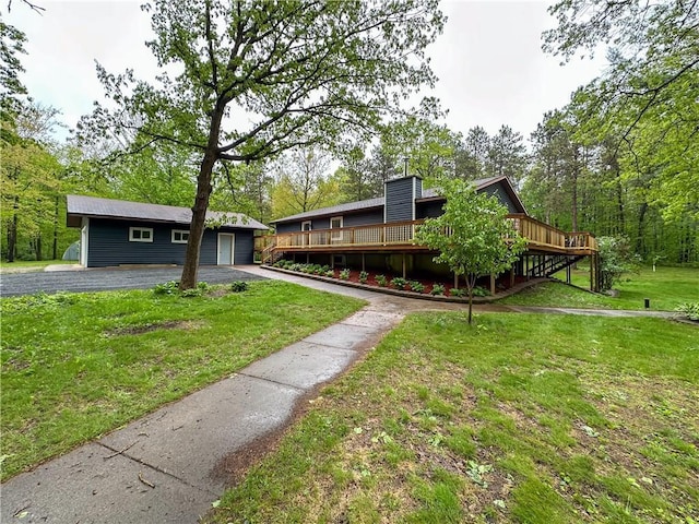 8054 223rd St, Cadott, WI 54727 - mid-century home with a deck, a front lawn, driveway, a garage, and a chimney