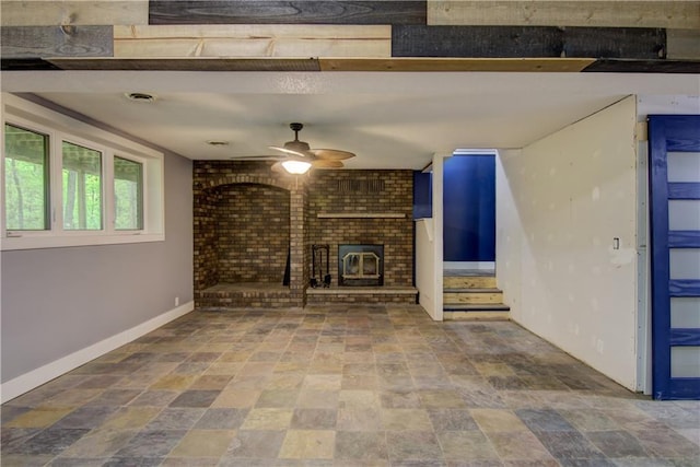 8054 223rd St, Cadott, WI 54727 - unfurnished living room featuring a ceiling fan, baseboards, stone finish flooring, and a brick fireplace