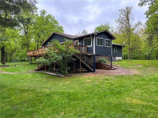 8054 223rd St, Cadott, WI 54727 - rear view of house with a deck, stairs, a lawn, and cooling unit