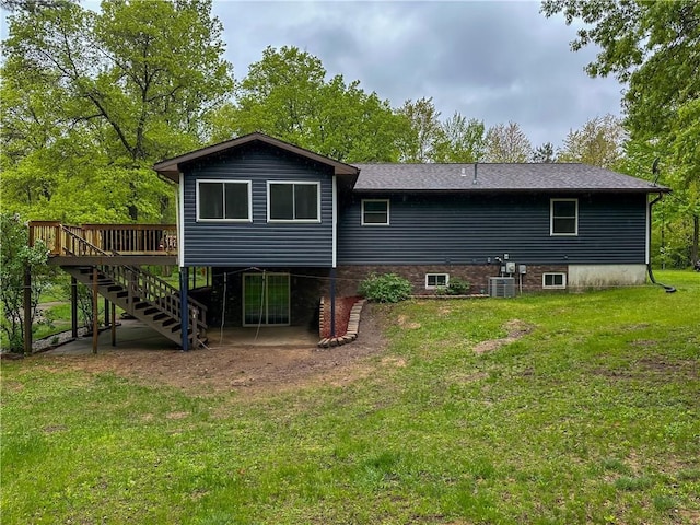 8054 223rd St, Cadott, WI 54727 - back of property with a deck, a yard, stairs, and central AC