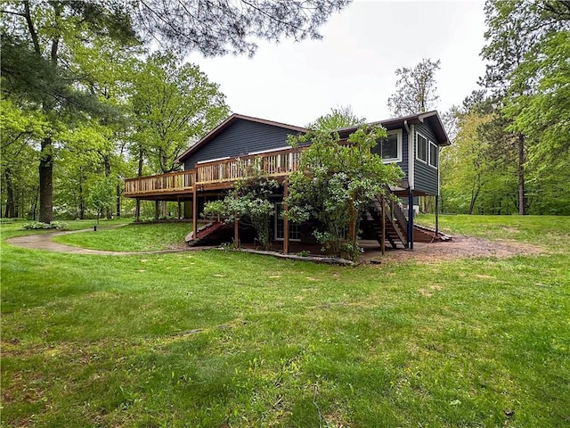 8054 223rd St, Cadott, WI 54727 - back of property with stairs, a deck, and a lawn
