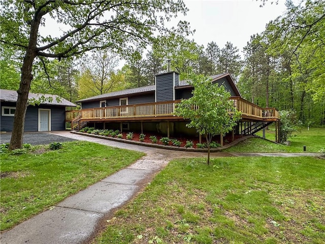 8054 223rd St, Cadott, WI 54727 - view of front of house with a wooden deck, a chimney, a front lawn, and stairway