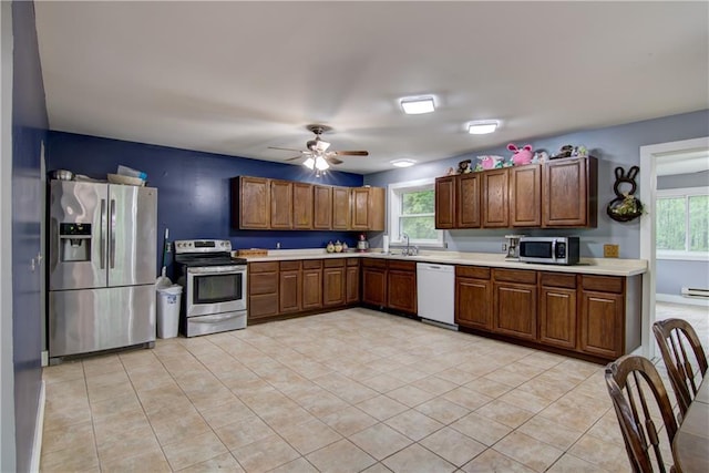 8054 223rd St, Cadott, WI 54727 - kitchen with stainless steel appliances, a sink, light countertops, light tile patterned floors, and healthy amount of natural light