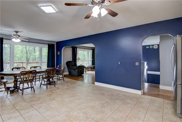 8054 223rd St, Cadott, WI 54727 - dining room featuring arched walkways, ceiling fan, and light tile patterned floors