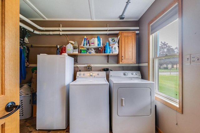 2424 Glendale Ave, La Crosse, WI 54601 - laundry room featuring washing machine and clothes dryer, plenty of natural light, and cabinet space