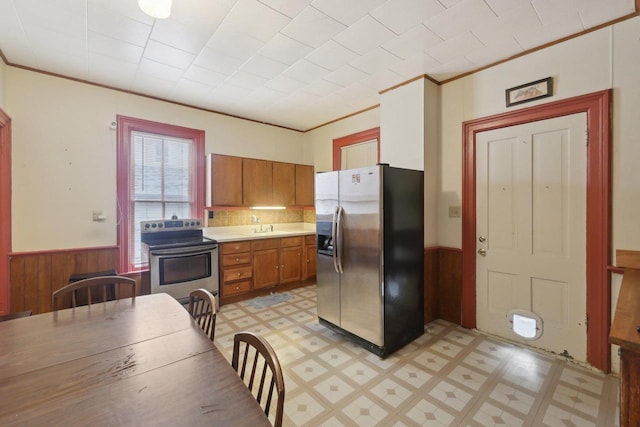 146 S Washington St, Waterloo, WI 53594 - kitchen featuring stainless steel appliances, light flooring, wainscoting, light countertops, and brown cabinets