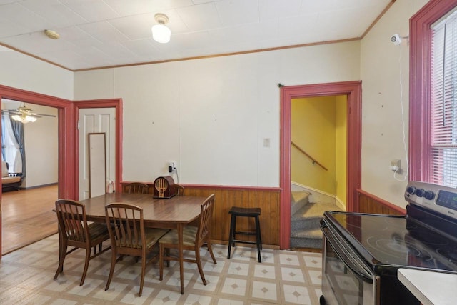 146 S Washington St, Waterloo, WI 53594 - dining space featuring crown molding, light floors, a wainscoted wall, stairway, and wooden walls