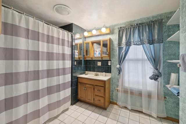 146 S Washington St, Waterloo, WI 53594 - full bath with tile patterned flooring, vanity, tile walls, and a shower with shower curtain