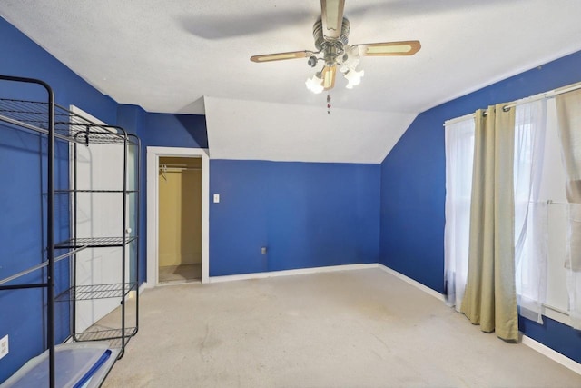 146 S Washington St, Waterloo, WI 53594 - unfurnished bedroom with carpet flooring, baseboards, lofted ceiling, and a ceiling fan