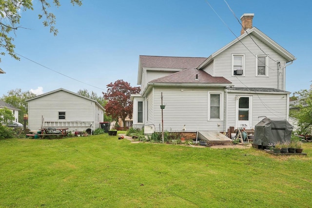 146 S Washington St, Waterloo, WI 53594 - rear view of house with a chimney, a yard, and a shingled roof