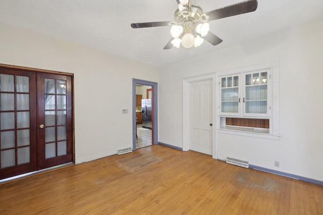 146 S Washington St, Waterloo, WI 53594 - spare room with a ceiling fan, wood finished floors, french doors, and baseboards
