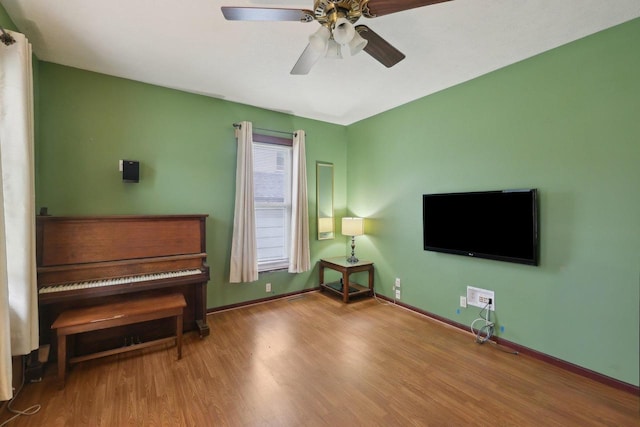 146 S Washington St, Waterloo, WI 53594 - living area with wood finished floors, a ceiling fan, and baseboards