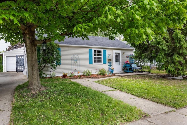 1667 Sherman Ave, Beloit, WI 53511 - view of front of property featuring an outbuilding, a garage, a front yard, and roof with shingles