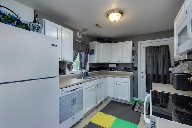 1667 Sherman Ave, Beloit, WI 53511 - kitchen featuring white appliances, a sink, white cabinets, and light countertops