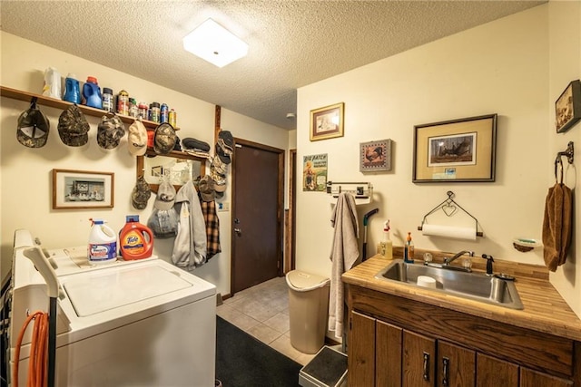 10790 Beal Ave, Hayward, WI 54843 - laundry room featuring independent washer and dryer, a sink, a textured ceiling, and light tile patterned floors