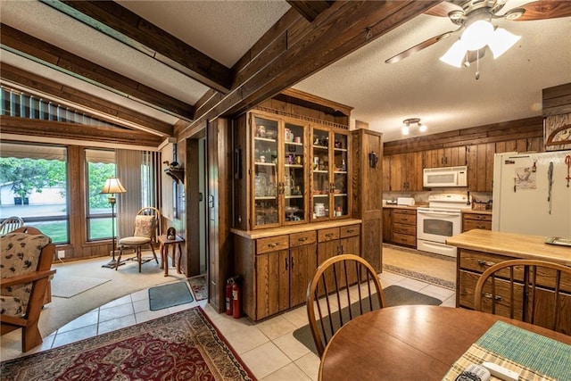 10790 Beal Ave, Hayward, WI 54843 - dining space featuring light tile patterned flooring, wood walls, a textured ceiling, and a ceiling fan