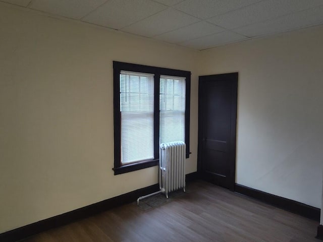1832 S 18th St Unit 1834, Milwaukee, WI 53204 - unfurnished room with radiator, wood finished floors, baseboards, and a paneled ceiling