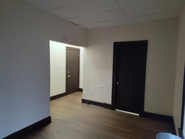 1832 S 18th St Unit 1834, Milwaukee, WI 53204 - empty room featuring wood finished floors, a paneled ceiling, and baseboards