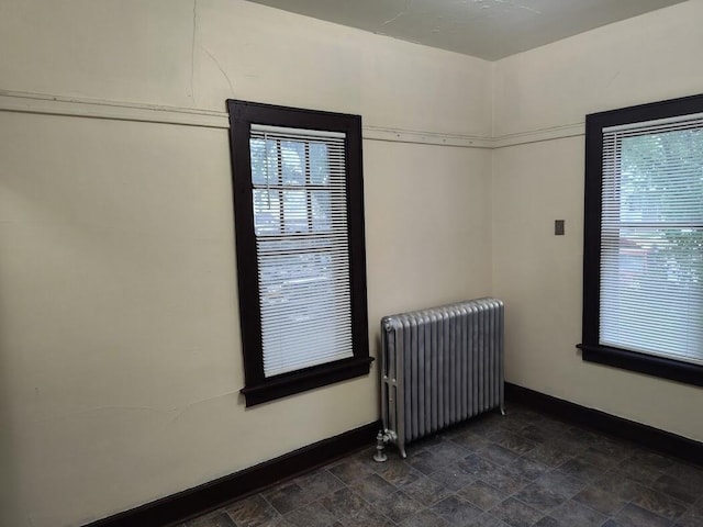 1832 S 18th St Unit 1834, Milwaukee, WI 53204 - unfurnished room with radiator, baseboards, and stone finish flooring