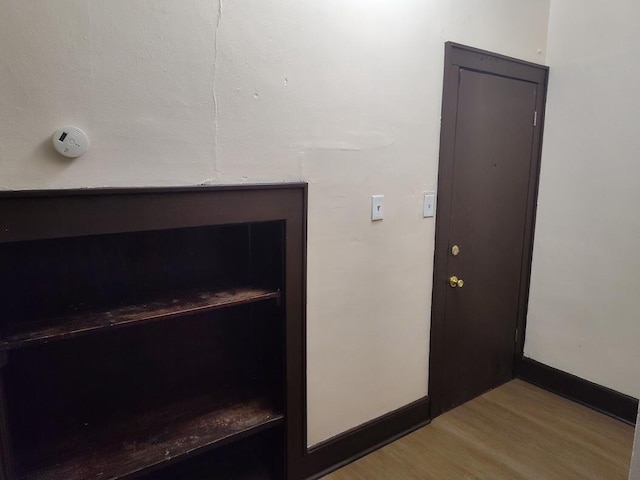 1832 S 18th St Unit 1834, Milwaukee, WI 53204 - detailed view of wood finished floors, baseboards, and a smoke detector