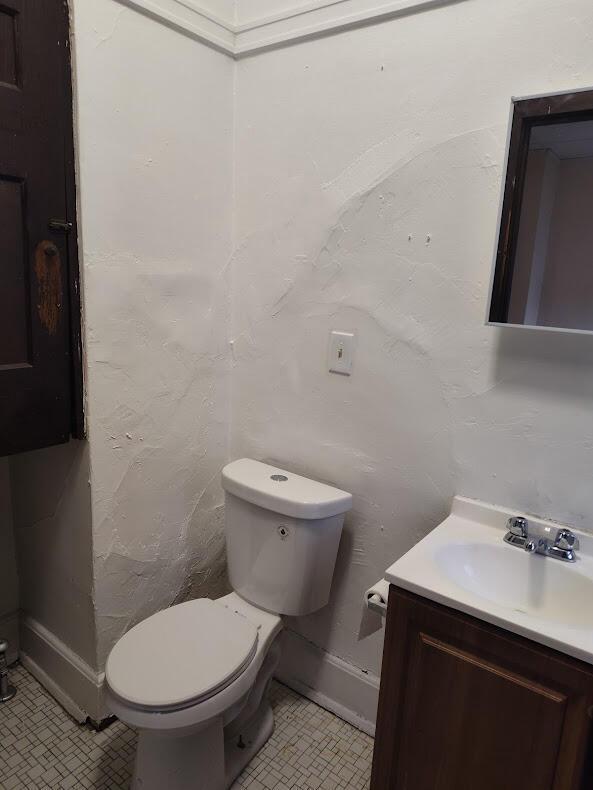1832 S 18th St Unit 1834, Milwaukee, WI 53204 - half bath featuring vanity, toilet, baseboards, and tile patterned flooring