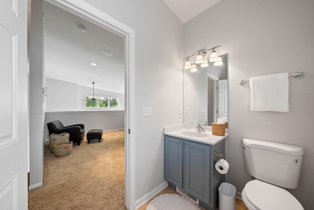 485 Mill St, Fontana, WI 53125 - bathroom featuring vaulted ceiling, vanity, toilet, and baseboards