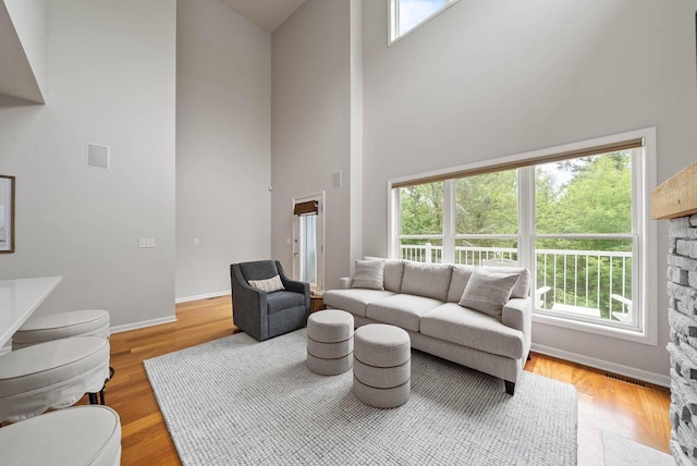 485 Mill St, Fontana, WI 53125 - living room featuring a high ceiling, baseboards, and wood finished floors