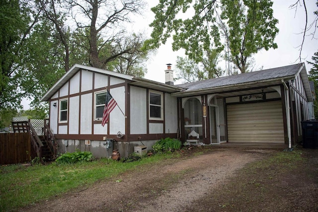 207 S Beach St, Plainfield, WI 54966 - view of front of house with dirt driveway, a garage, and a chimney