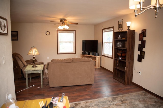 207 S Beach St, Plainfield, WI 54966 - living room featuring wood finished floors, a ceiling fan, a chandelier, and baseboards