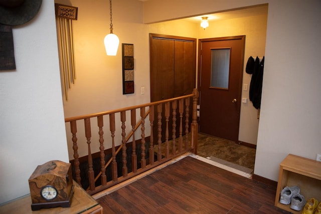207 S Beach St, Plainfield, WI 54966 - corridor with wood finished floors, an upstairs landing, and baseboards