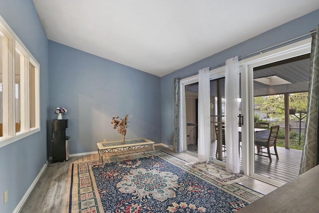 8124 W Imperial Dr, Franklin, WI 53132 - interior space with wood finished floors, vaulted ceiling, and baseboards
