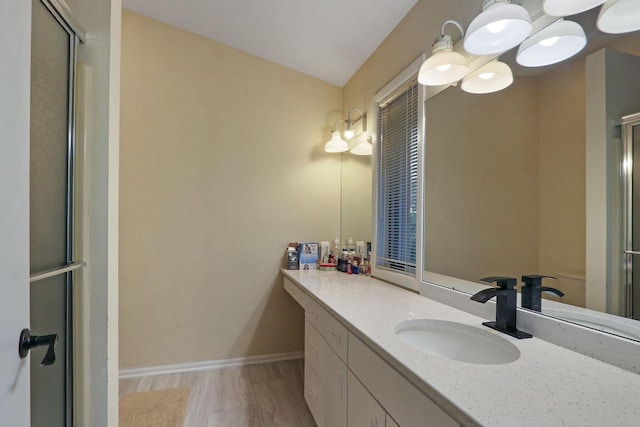 8124 W Imperial Dr, Franklin, WI 53132 - full bathroom with vanity, a shower with door, baseboards, and a chandelier