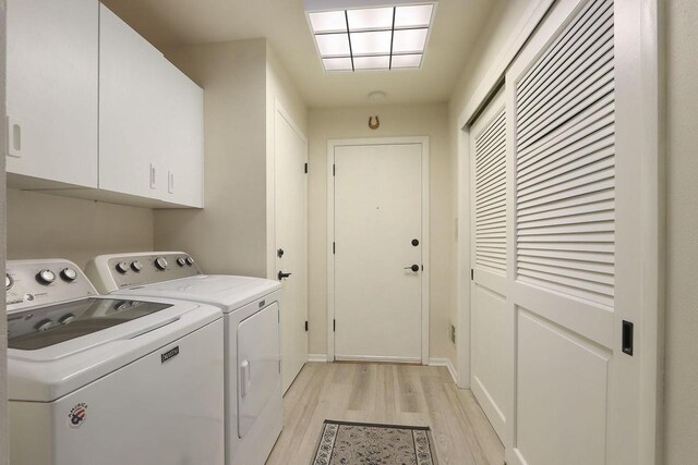 8124 W Imperial Dr, Franklin, WI 53132 - laundry room featuring cabinet space, separate washer and dryer, and light wood finished floors