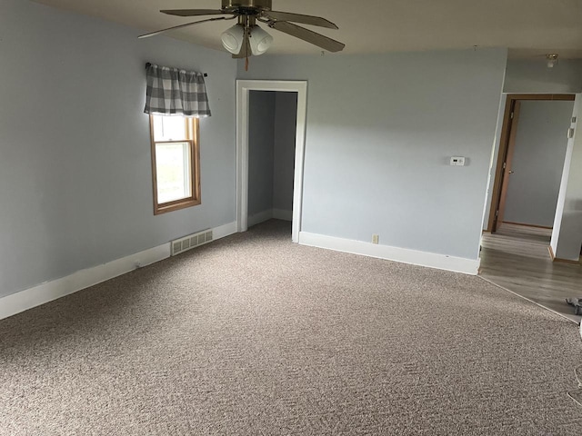 6831 Marken Rd, Valders, WI 54245 - unfurnished room featuring a ceiling fan, baseboards, and carpet floors