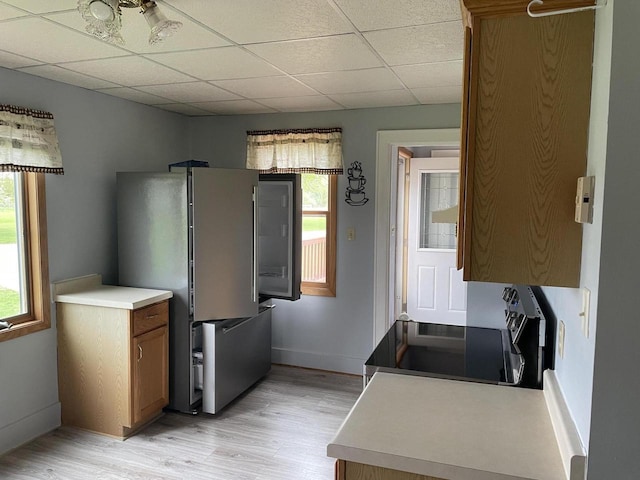 6831 Marken Rd, Valders, WI 54245 - kitchen featuring freestanding refrigerator, healthy amount of natural light, light wood-type flooring, and a paneled ceiling