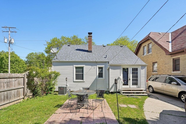 4227 W Concordia Ave, Milwaukee, WI 53216 - back of house featuring a chimney, roof with shingles, central AC, and a patio