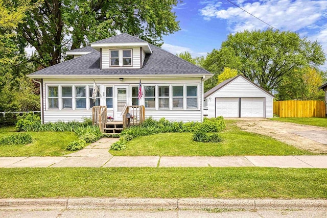 25 E 1st St, Clintonville, WI 54929 - bungalow-style home featuring an outdoor structure, a detached garage, and roof with shingles